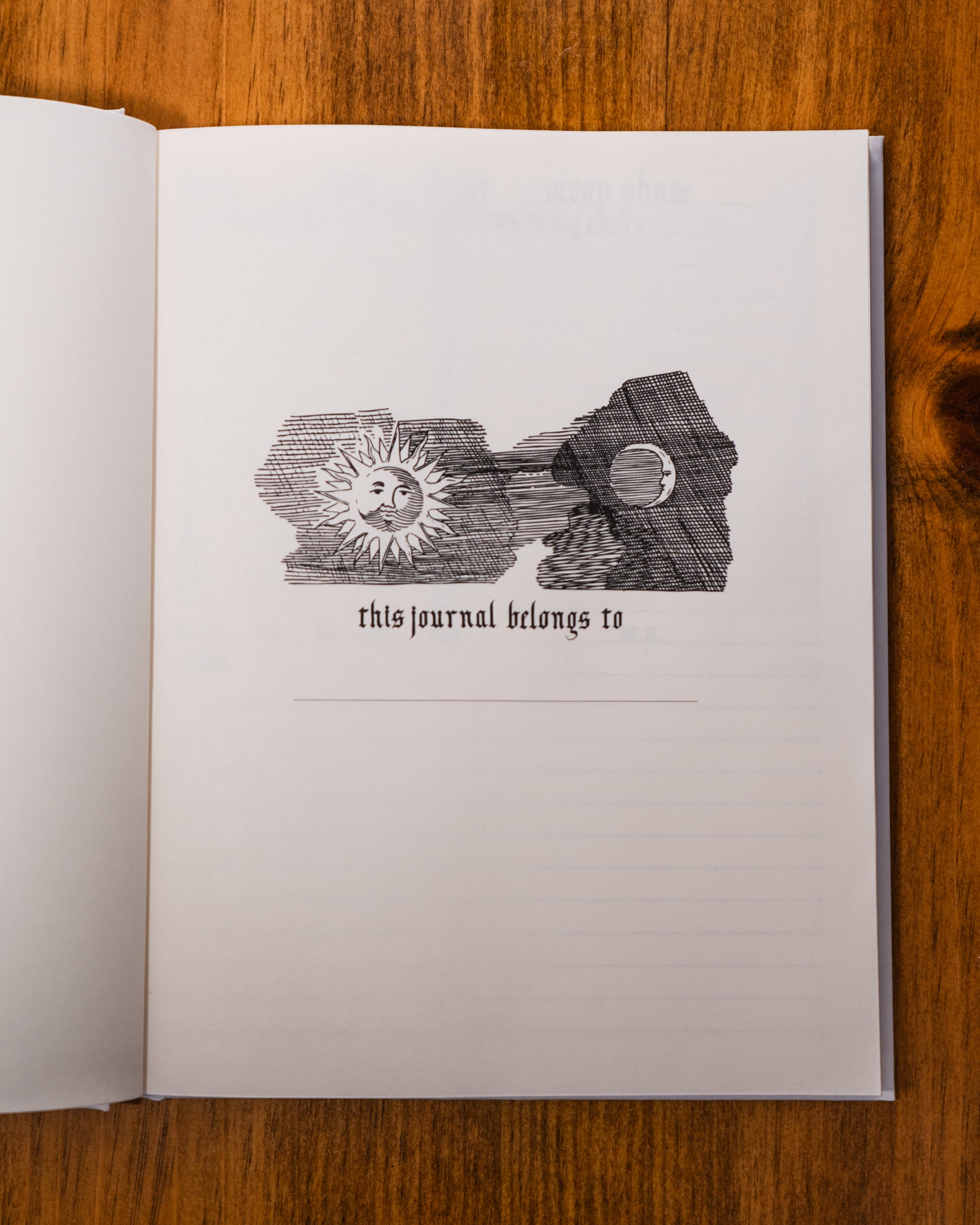 Open journal with decorative cover on a wooden surface